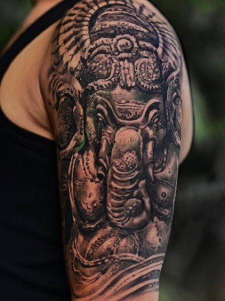 Lord Ganesha sculpture tattoo on the upper arm
